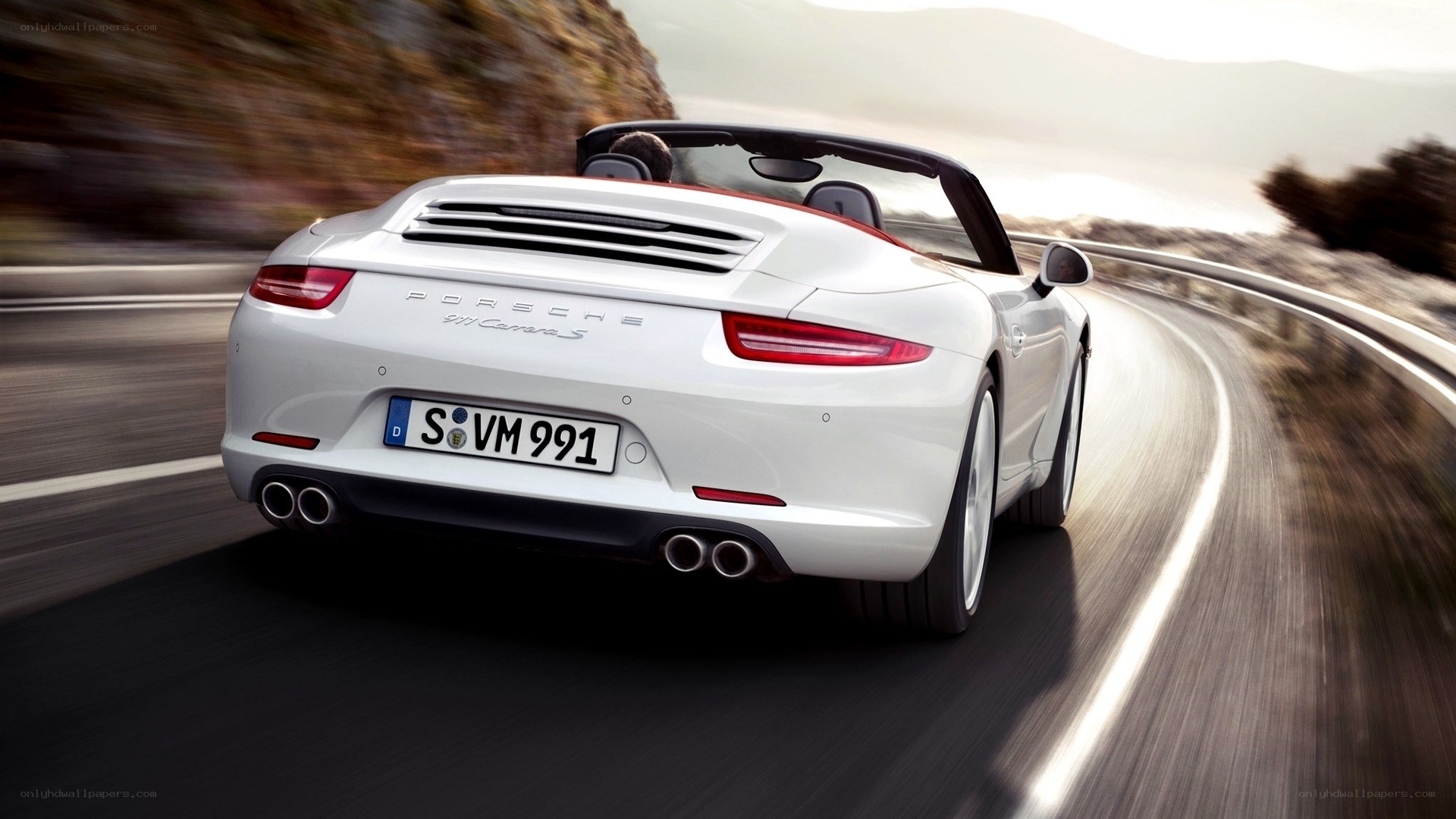 White Porsche convertible on road