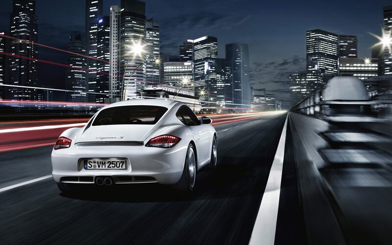 White Porsche driving at night
