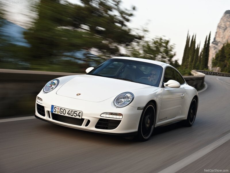 White Porsche driving on a road
