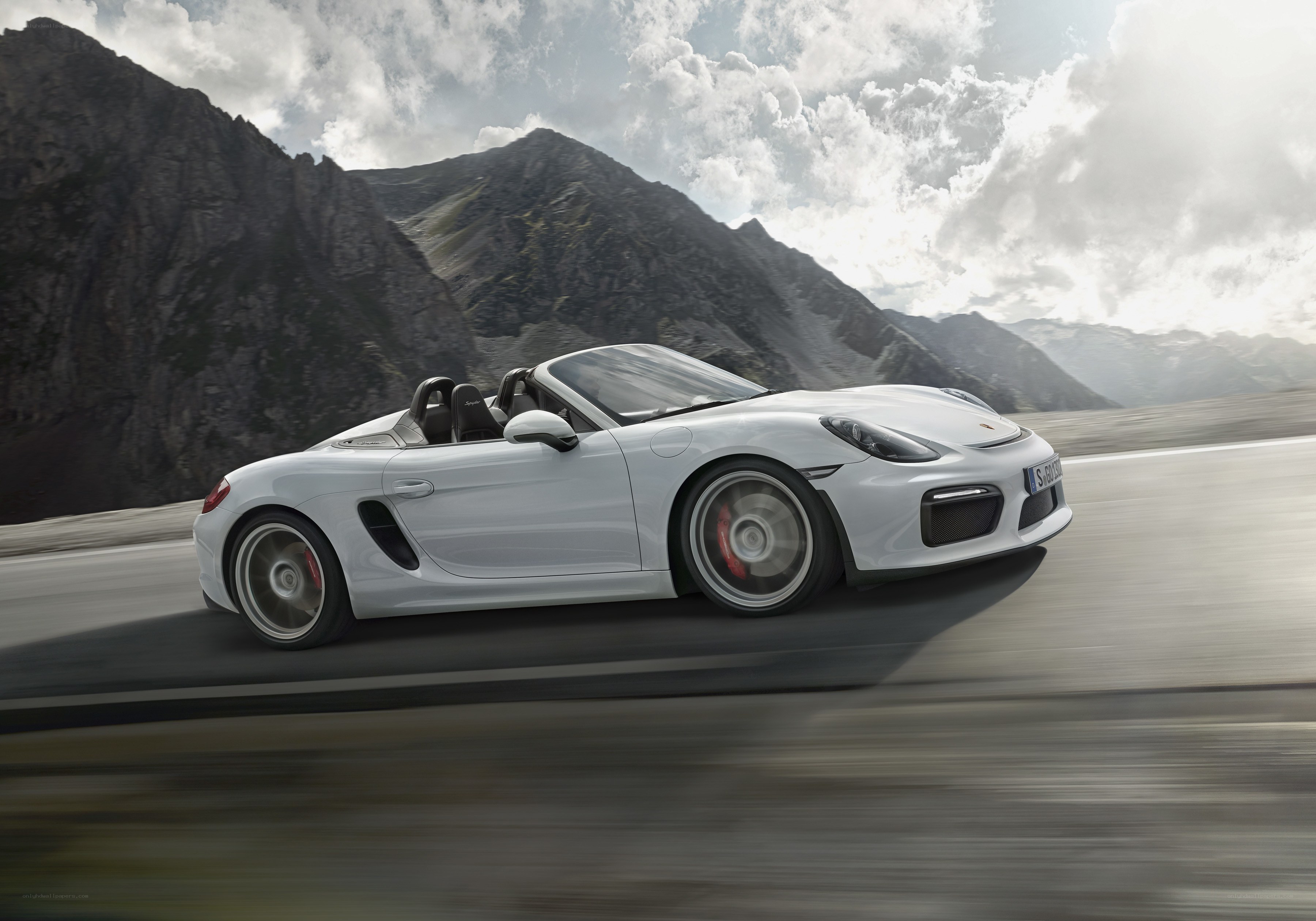 White Porsche driving on mountain road