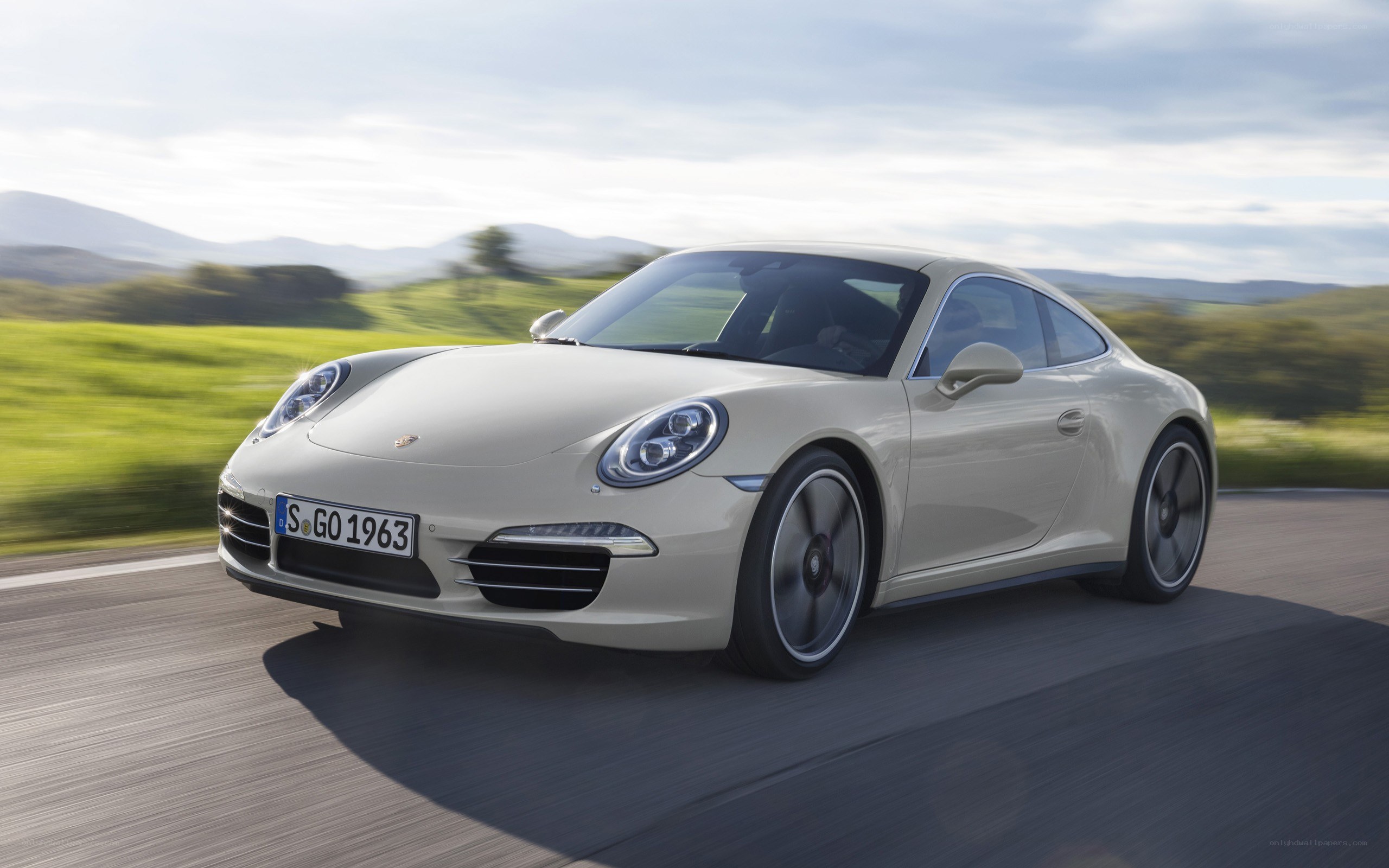 white porsche driving on road