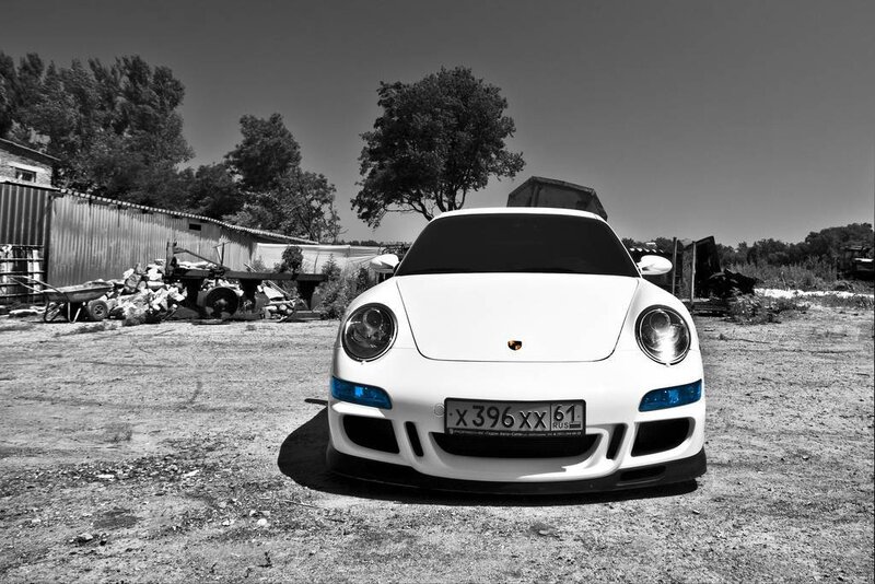 white porsche in a junkyard