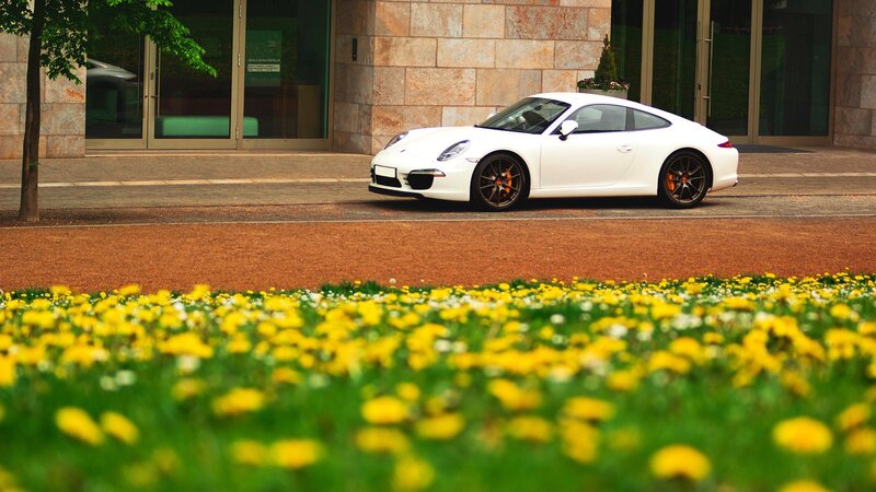 White Porsche in front of building