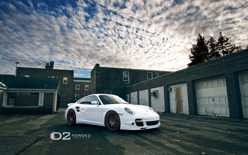 white porsche in industrial lot