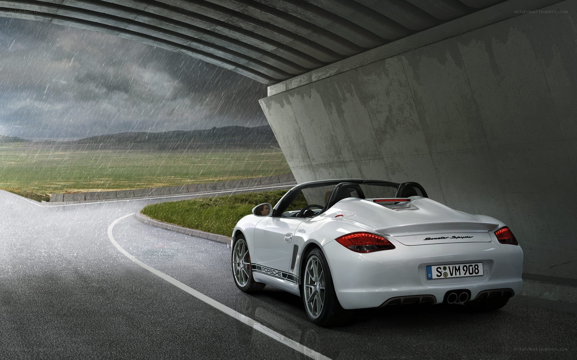 White Porsche in rain under bridge