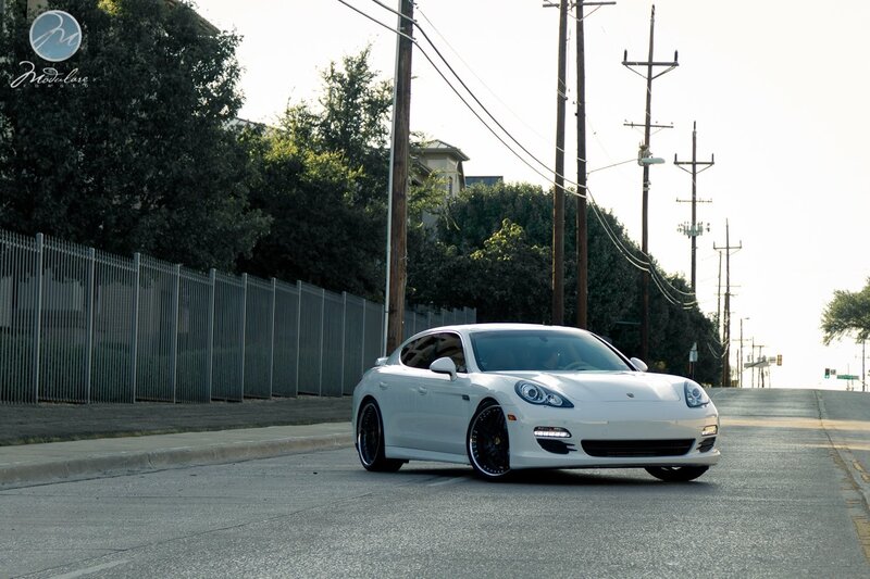 white porsche on a city street