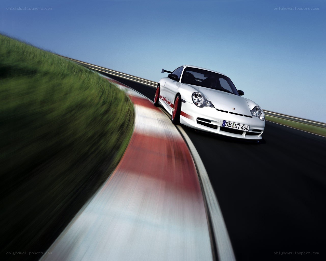 White Porsche on a racetrack