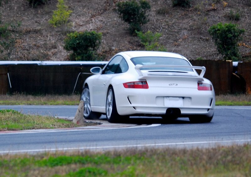 white porsche on a racetrack