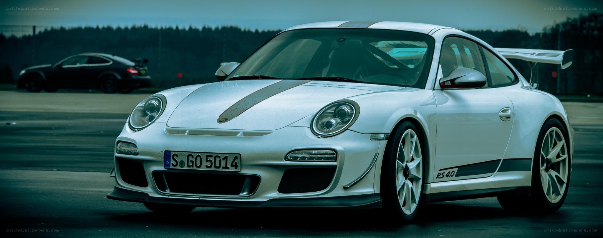 White Porsche on a racetrack