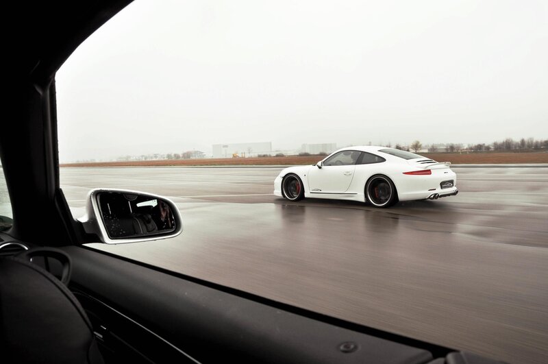 White Porsche on a wet track