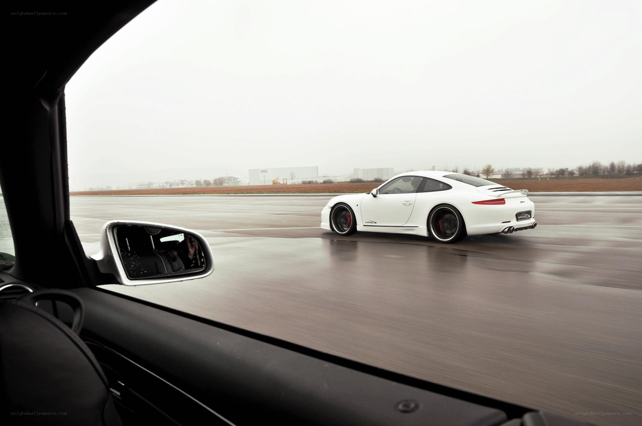 White Porsche on a wet track