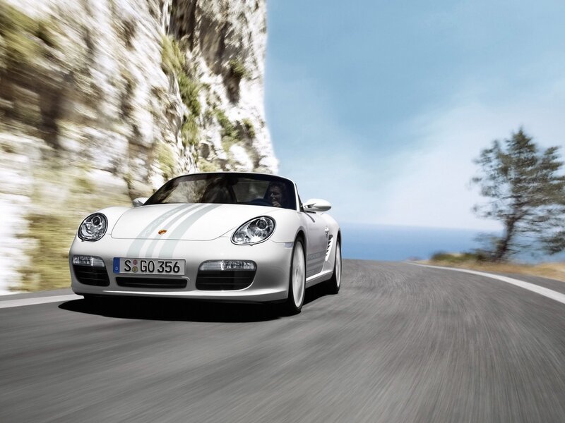 White Porsche on coastal road