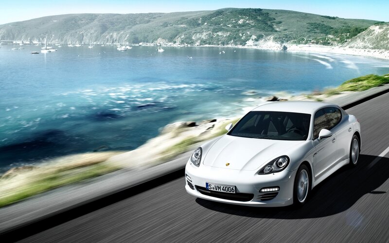 White Porsche on coastal road