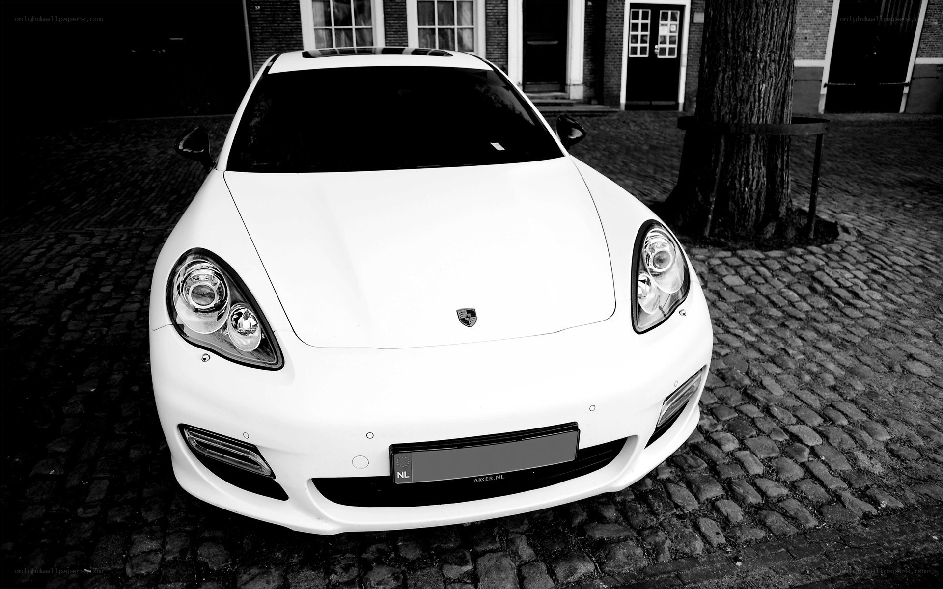 white porsche on cobblestones