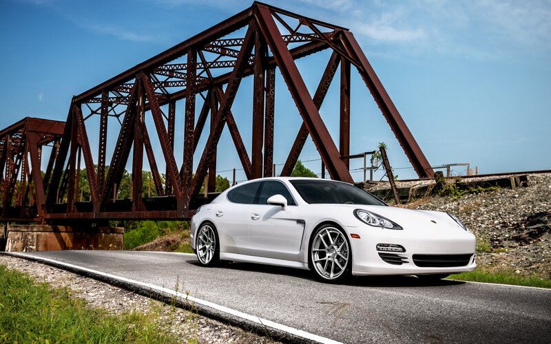 White Porsche on road near bridge