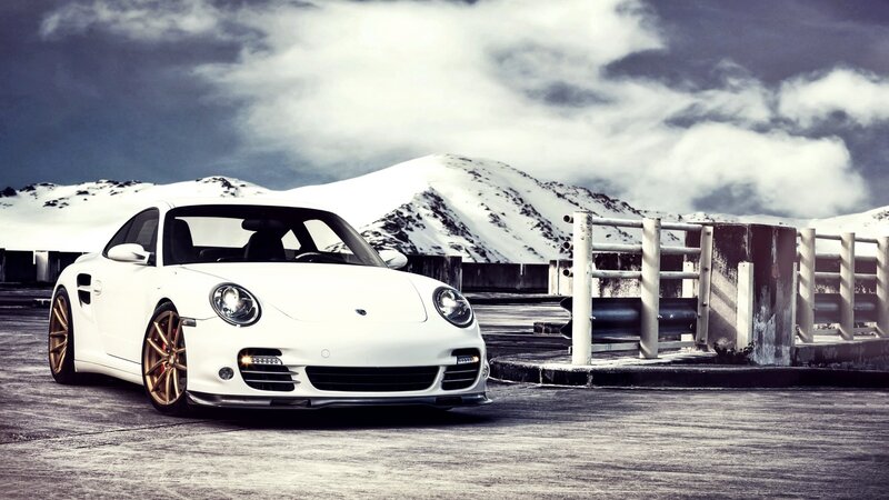 White Porsche on snowy mountain road