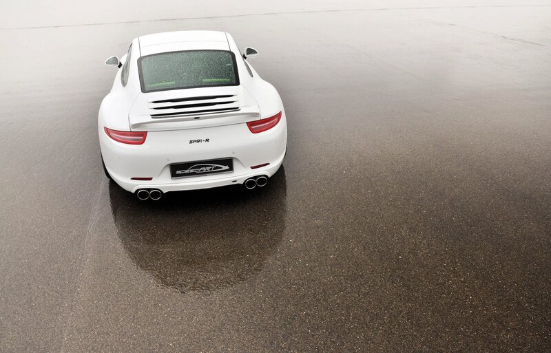 White Porsche on wet pavement