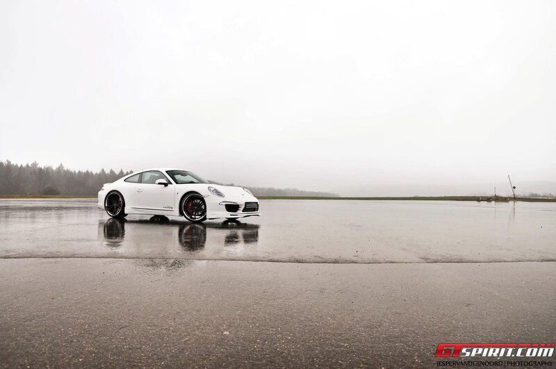 White Porsche on wet tarmac