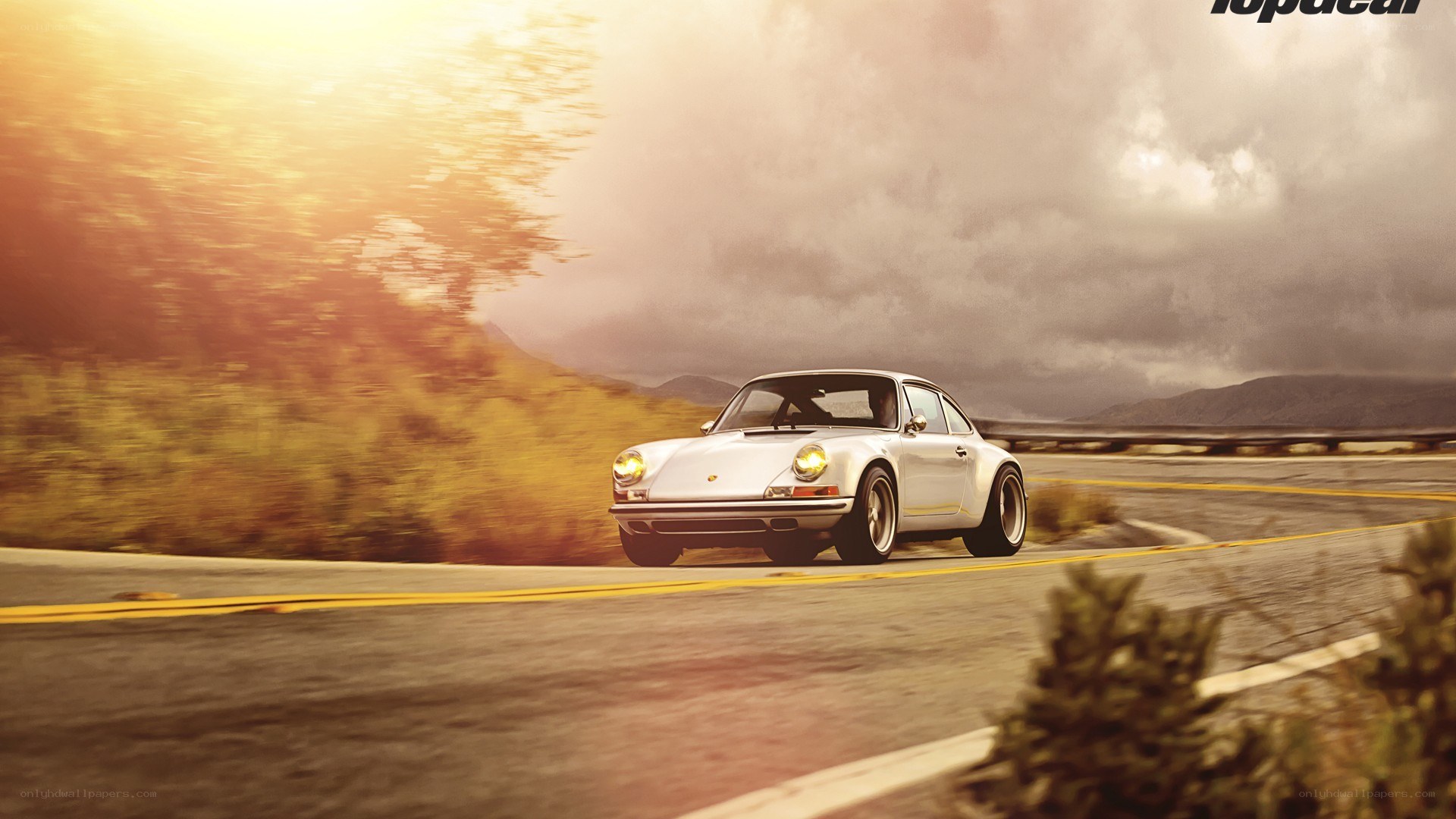 white porsche on winding road