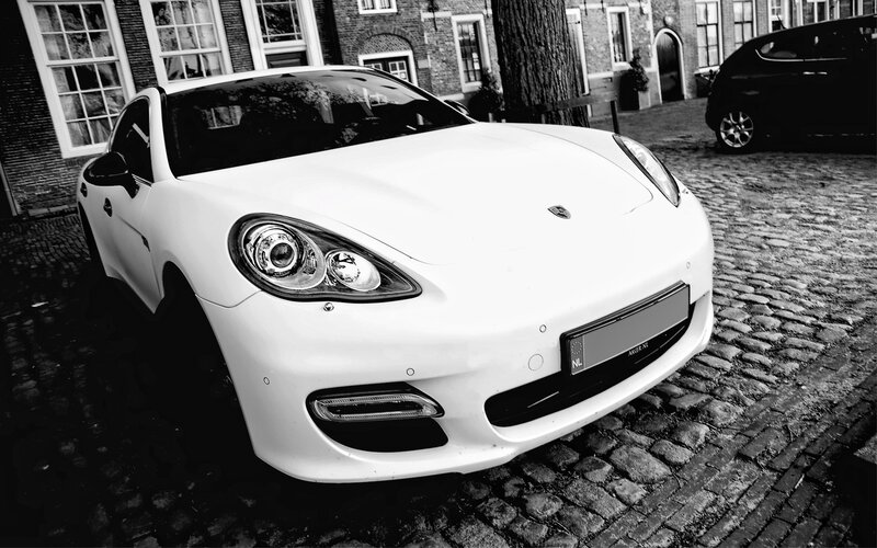 White Porsche Panamera on cobblestones
