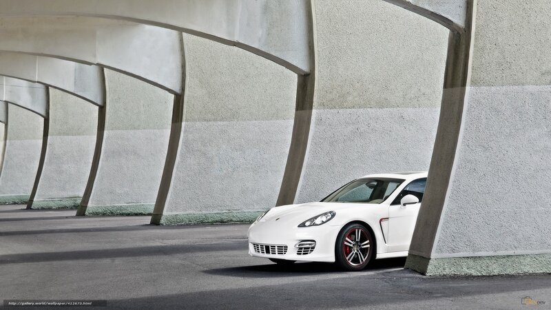 White Porsche parked under arches