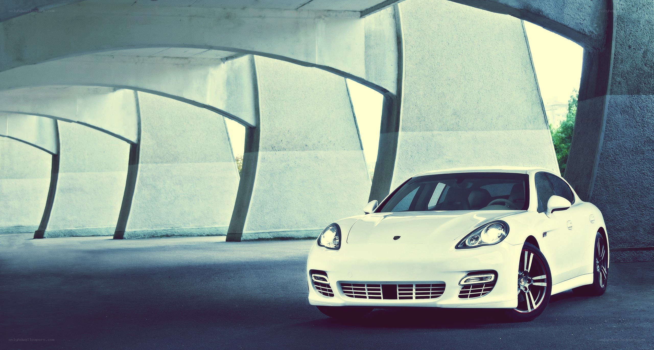 white porsche parked under bridge