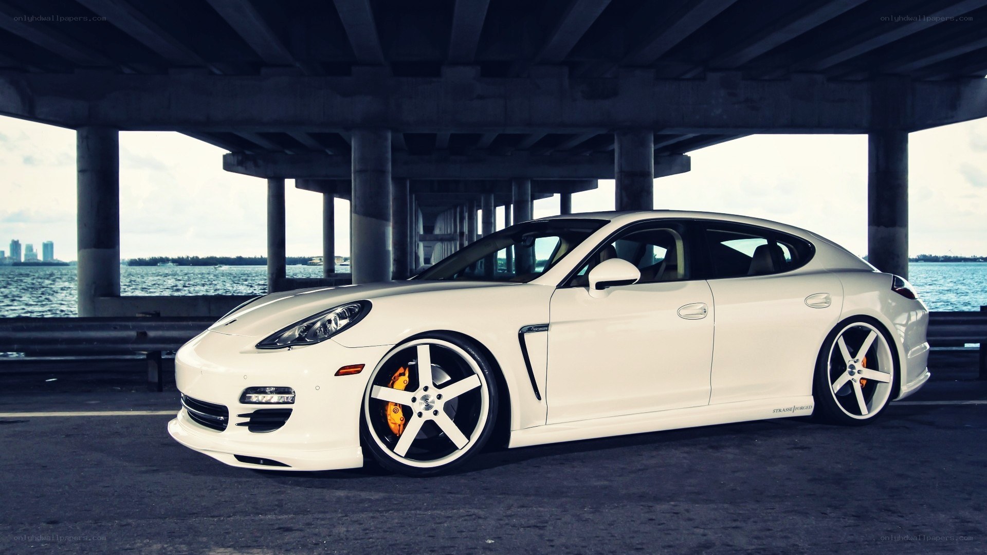 white porsche parked under bridge