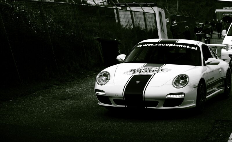 White Porsche race car on track