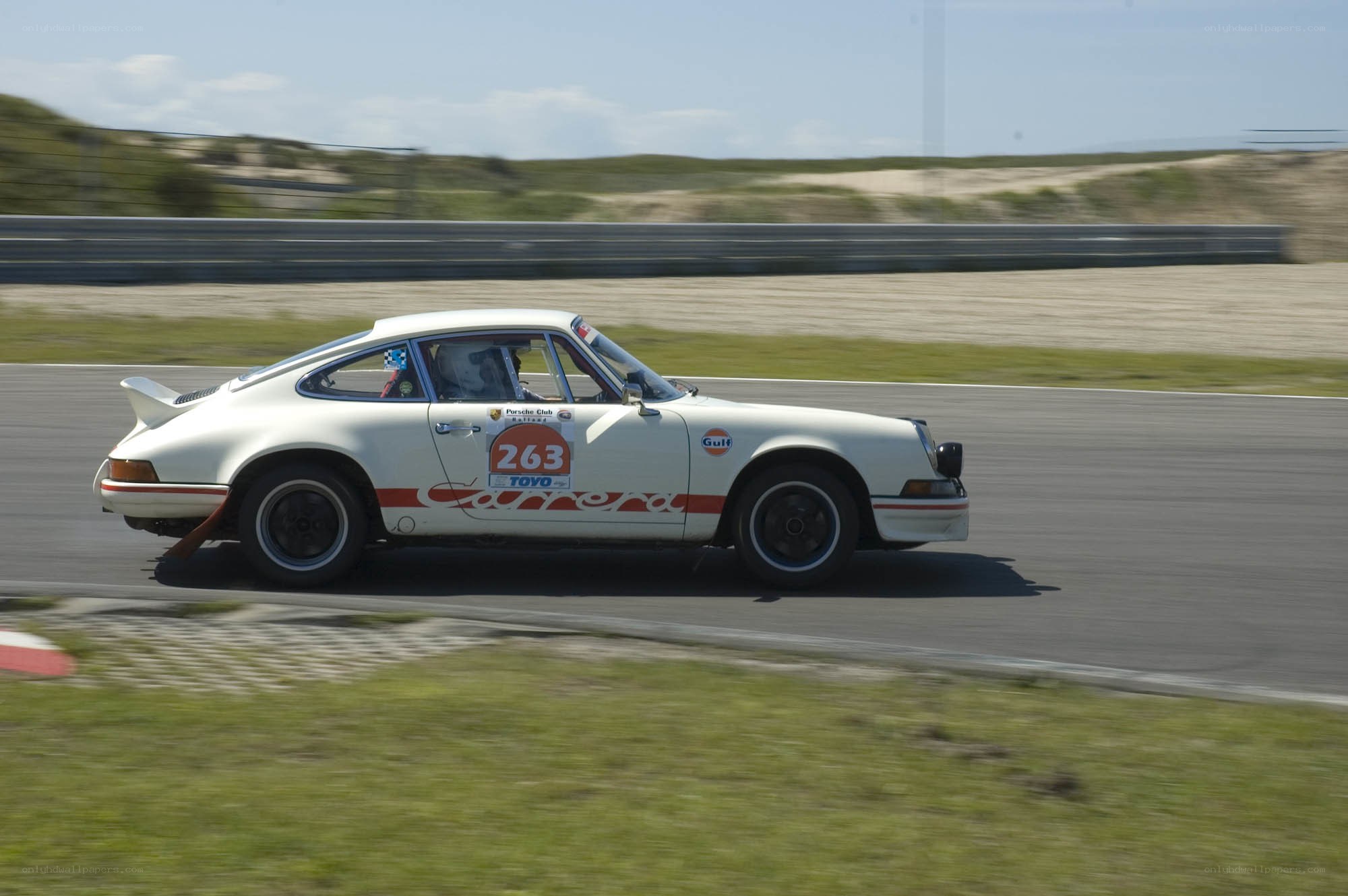 white porsche racing on track