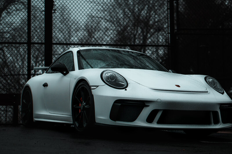 White Porsche Sports Car — Dramatic, Photograph, Fence