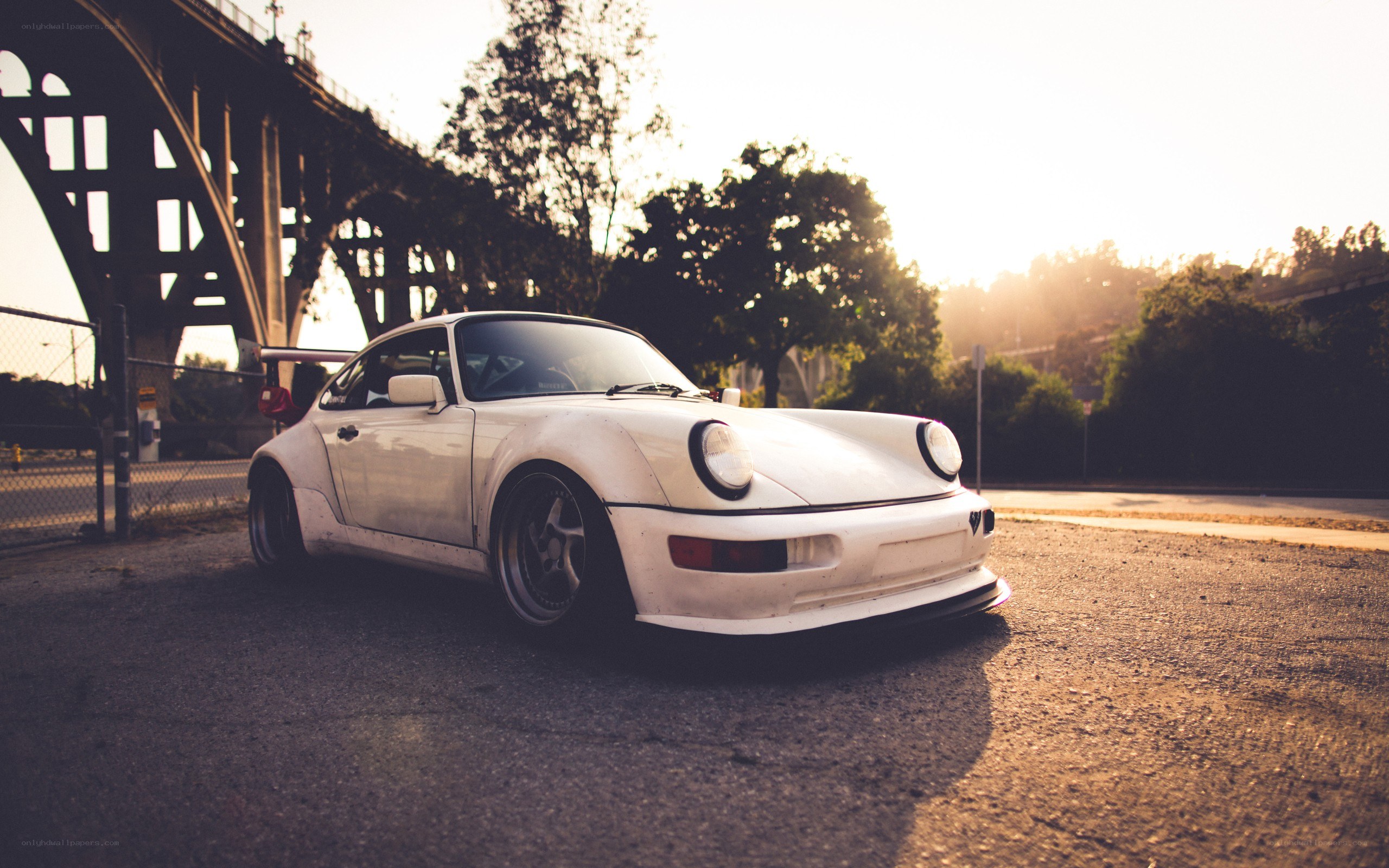 White Porsche under a bridge
