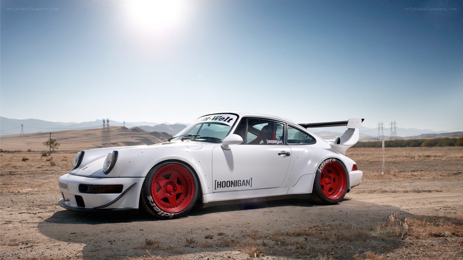 White Porsche with red wheels