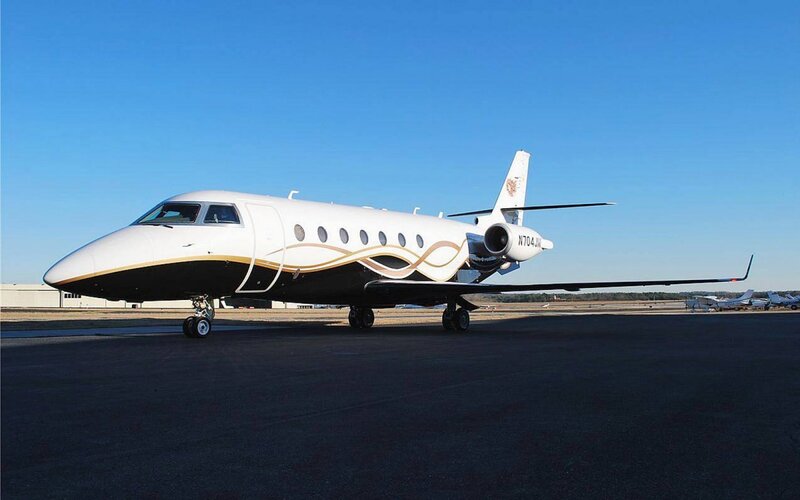 white private jet on tarmac