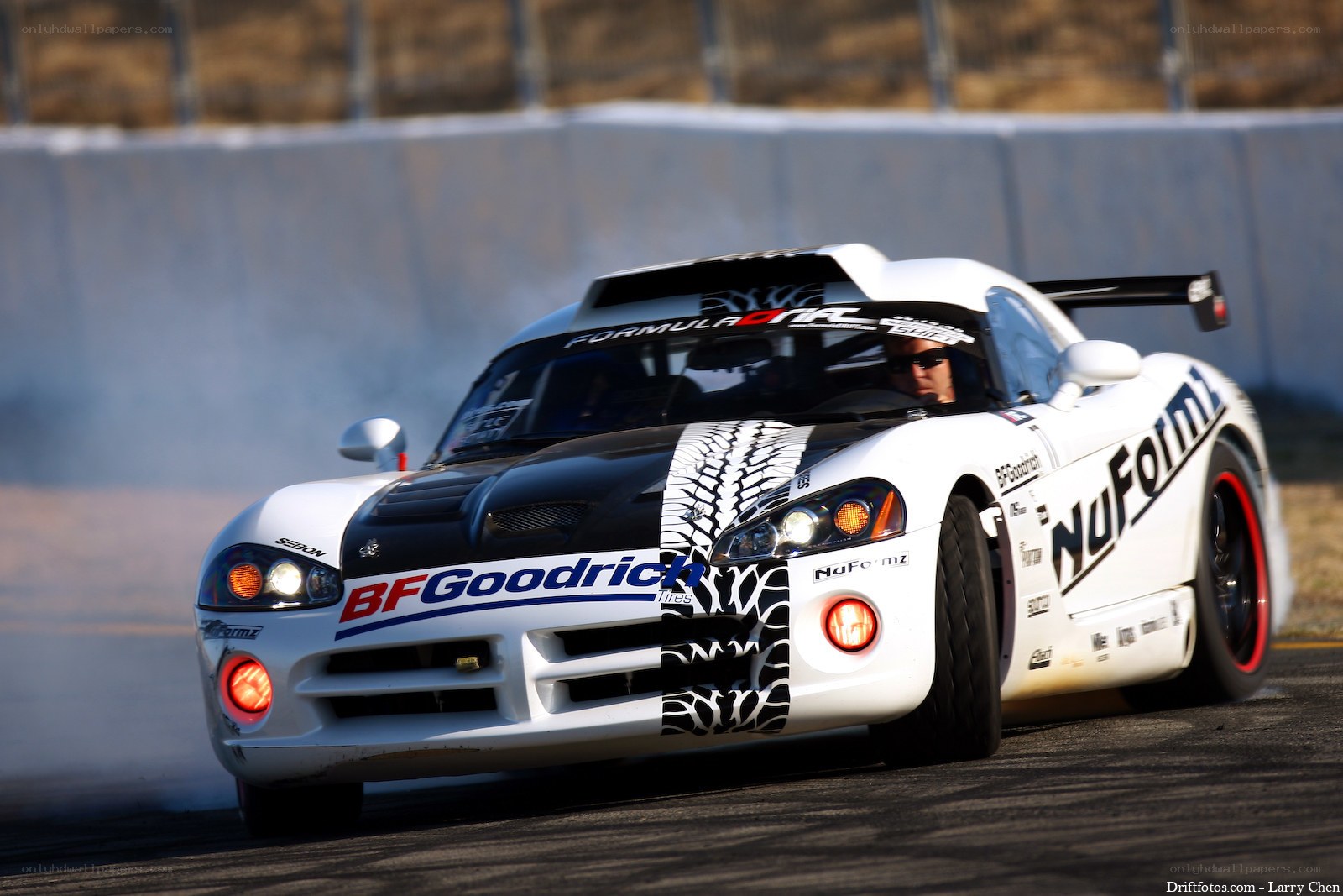 White race car drifting on track