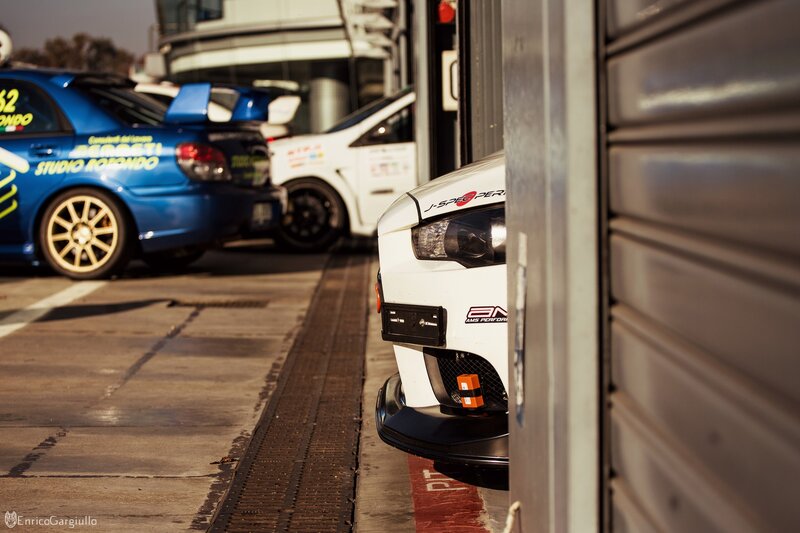 White Race Car in Garage — Dramatic, Afternoon, Photograph