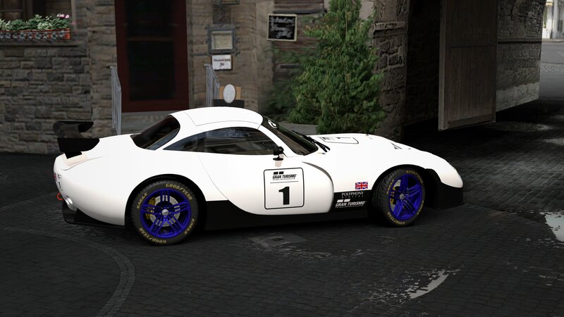 white race car on cobblestone street