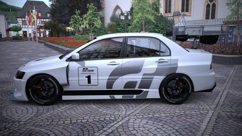 white race car on cobblestones