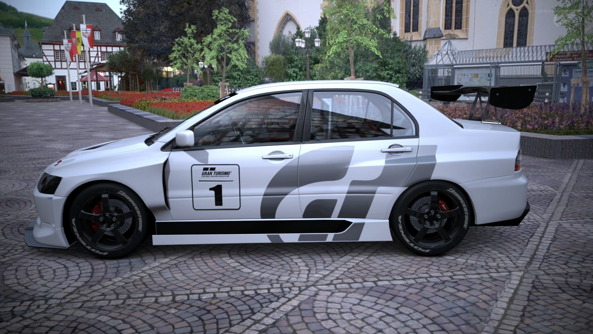 white race car on cobblestones