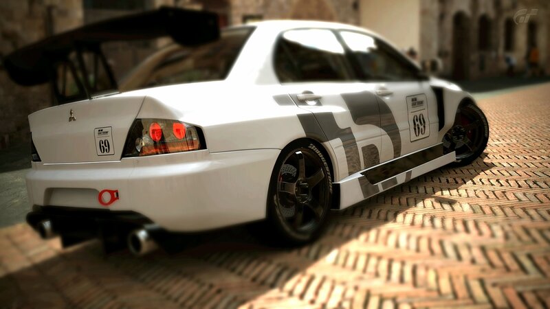 white race car on cobblestones