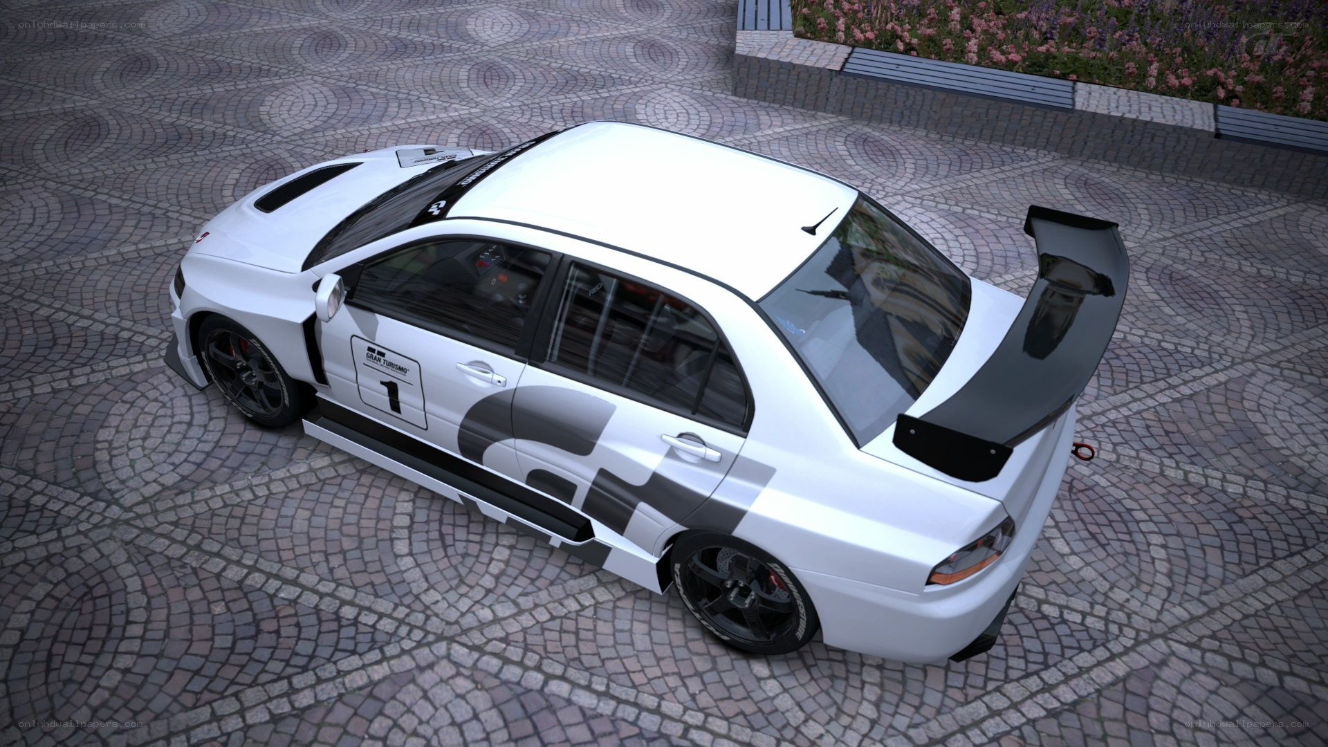 white race car on cobblestones