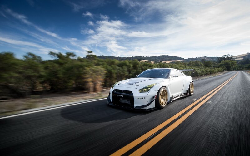 White Race Car on Road — Dynamic, Afternoon, Photograph