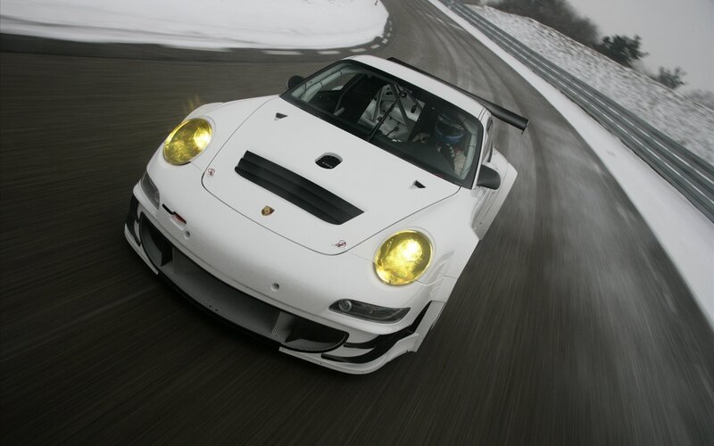 white race car on snowy track