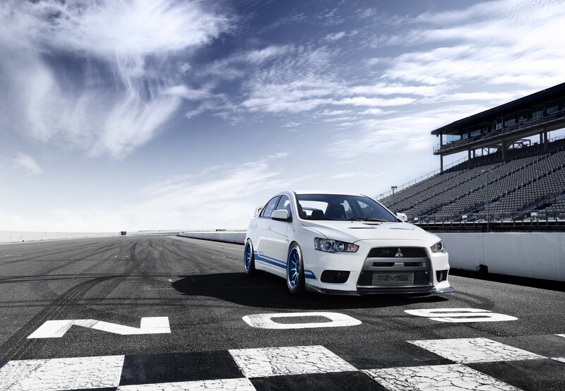 White Race Car on Track — Dramatic, Afternoon, Photograph, Race Track, Grandstand, Sky