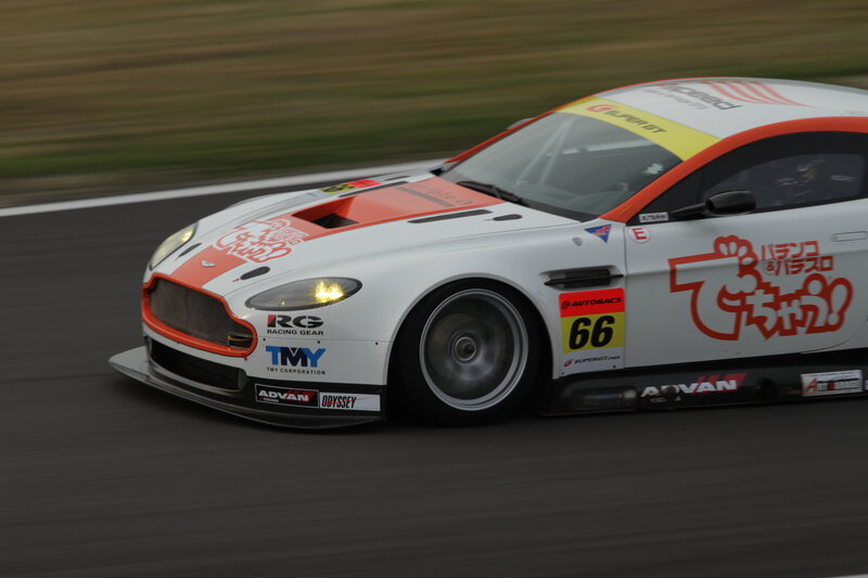 White Race Car on Track — Dynamic, Night, Photograph, Race Car, Sponsors