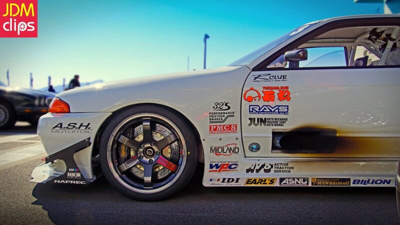 white race car with sponsor decals