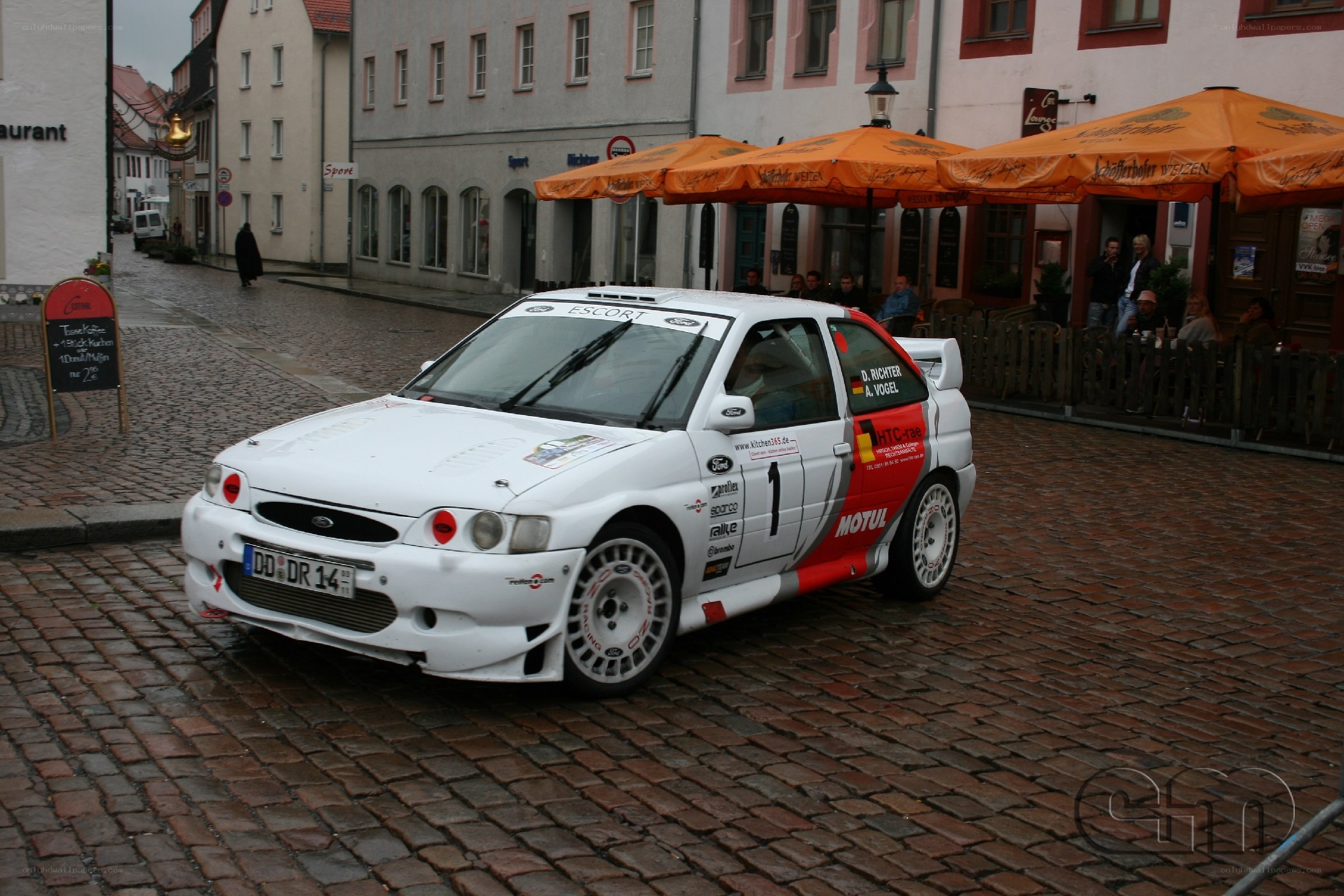 White rally car on cobblestones