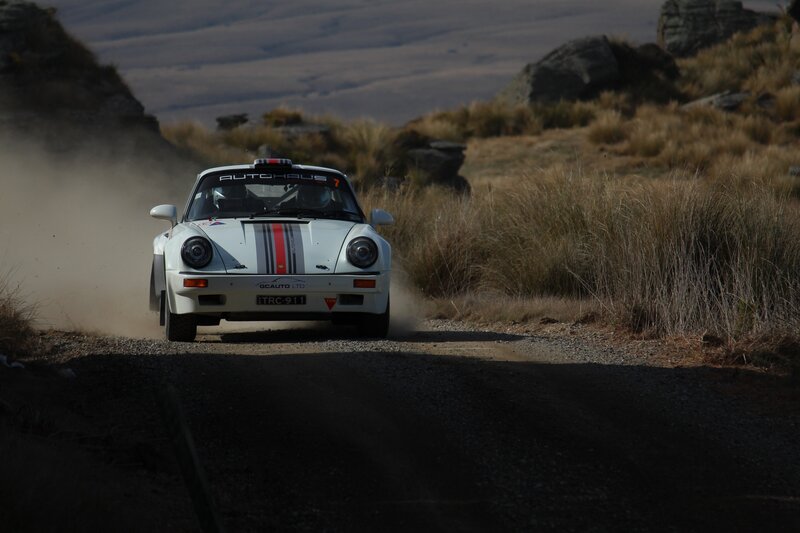 White rally car on dirt road