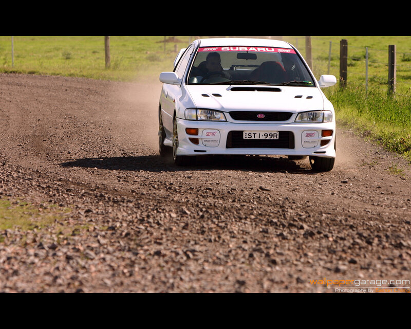 white rally car on dirt road