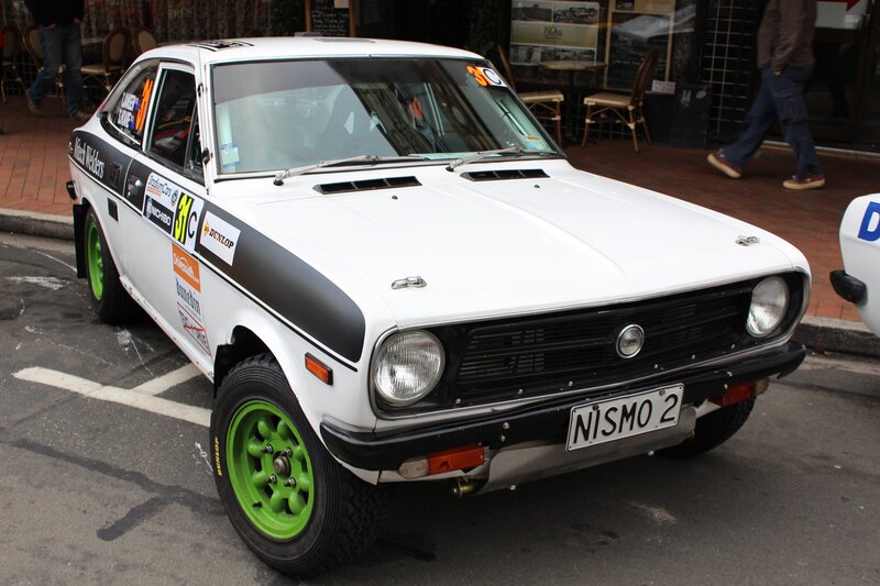 white rally car with green wheels