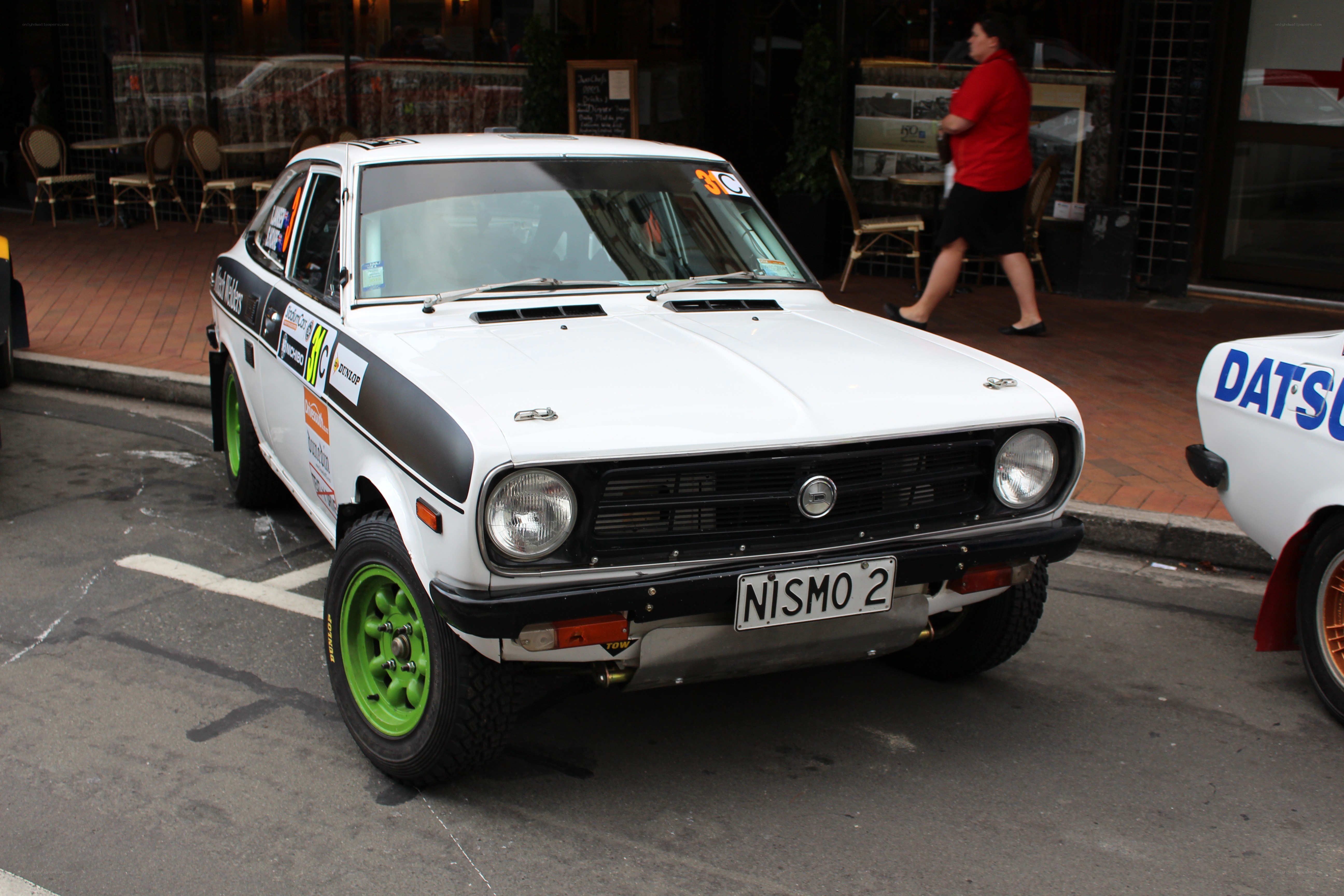 White rally car with green wheels